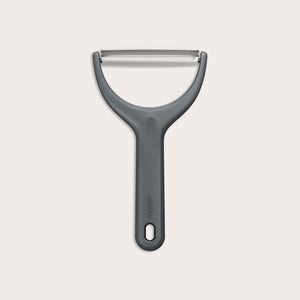 The Zyliss Wide Peeler features a Y-shaped design, ergonomic handle, and horizontal stainless steel blade, shown against a simple light background. 