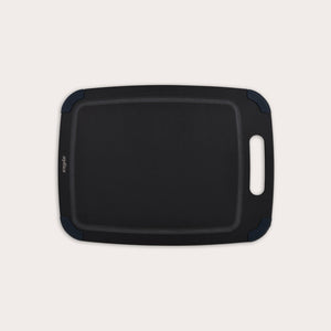 The Zyliss Wood Fibre Cutting Board is a rectangular, black, eco-friendly board with rounded corners, groove edging, right-side handle cutout, and dark blue corner accents. Made from recycled wood fibres. Shown on a plain white background. #Medium