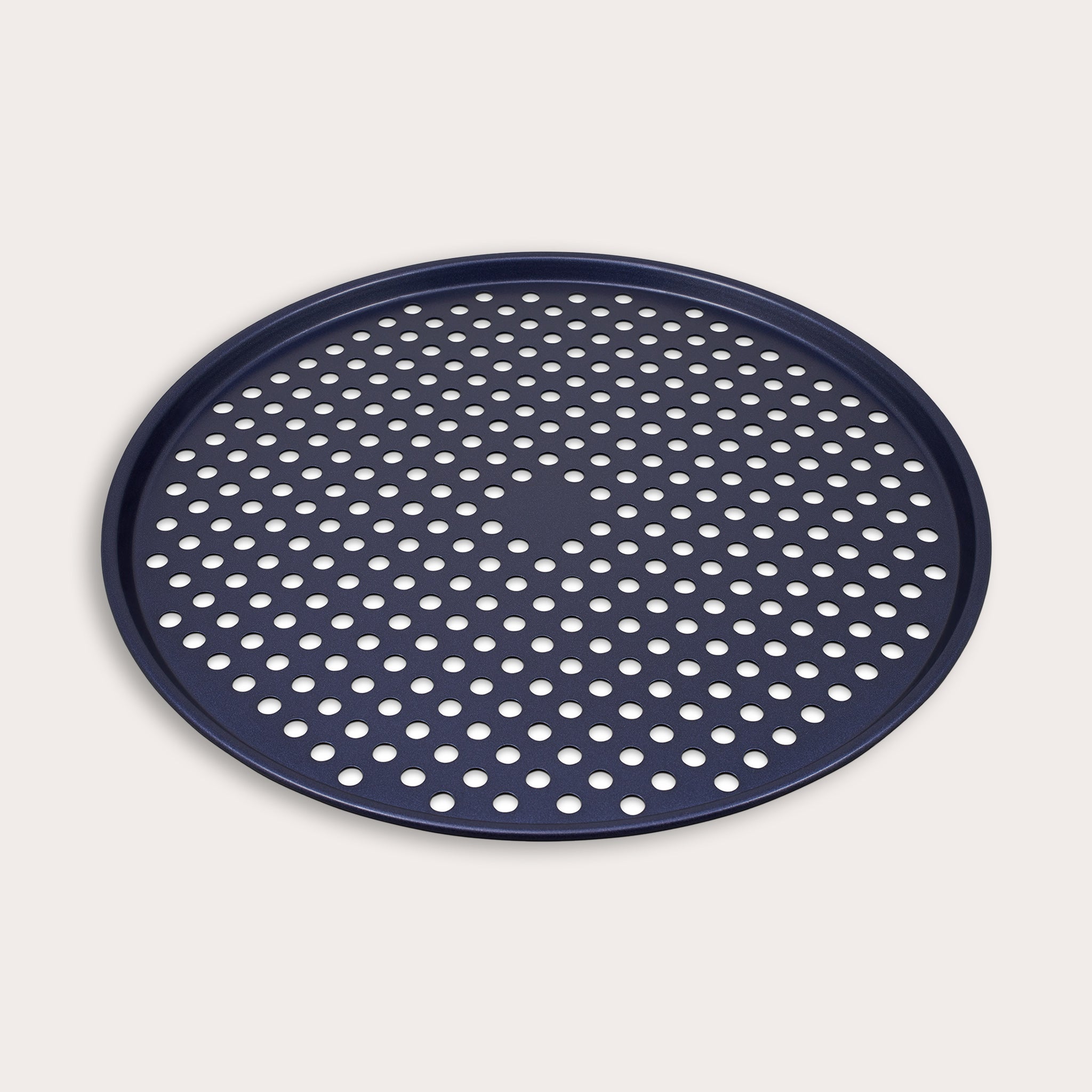 A round, dark blue pizza pan with a raised edge and evenly spaced perforated holes across the bottom, displayed on a plain, light background.