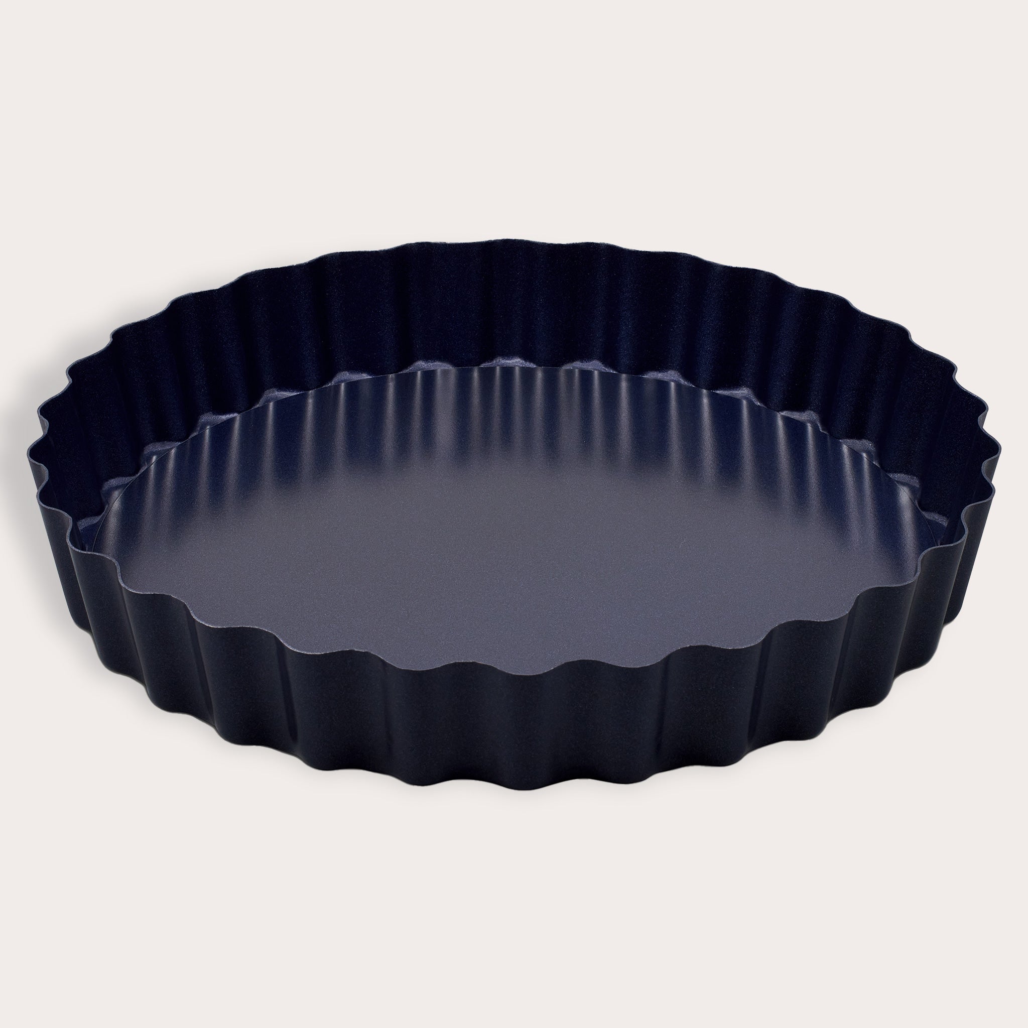 The Zyliss Durable Non-Stick Tart Pan, made from strong carbon steel with fluted edges and a non-stick coating, is shown on a plain light background—ideal for baking tarts or quiches.