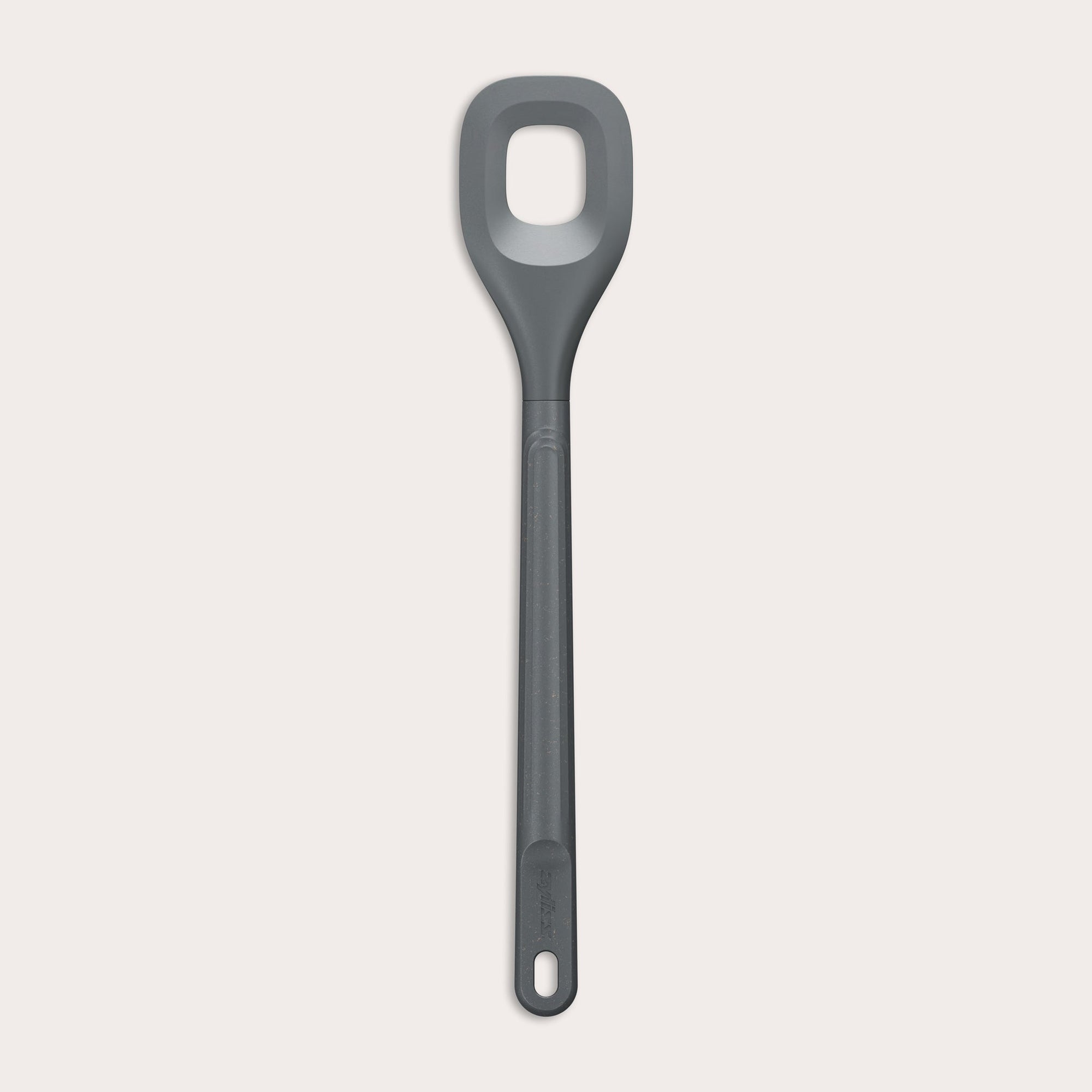 The Zyliss Square Mixing Spoon is a gray, heat-resistant silicone utensil with a long handle and a rectangular hole in the head. Shown on a plain light background, its dishwasher safe for easy cleaning. 