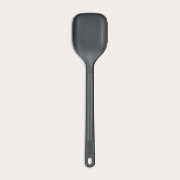#large A durable Zyliss Spoon in dark gray silicone, featuring a long handle with a hole at the end, displayed on a plain light background. #Large