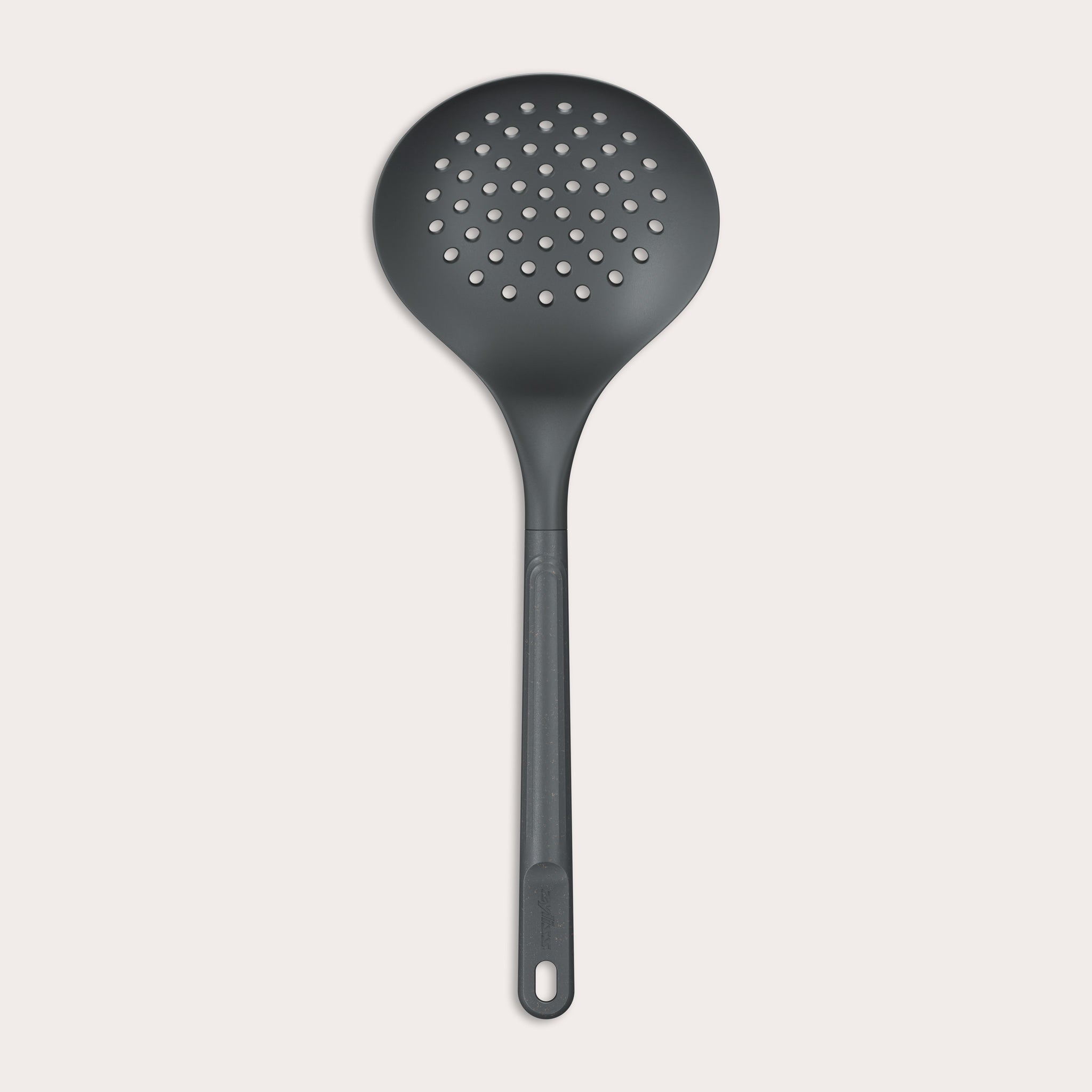 The Zyliss Skimmer features a black, round perforated head and an ergonomic, heat-resistant handle with a hanging hole, displayed against a plain light background. 