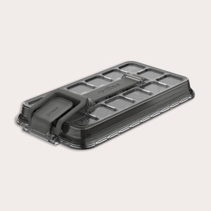 A rectangular, transparent plastic lid for the Zyliss Press & Pull Ice Cube Tray with a gray foldable handle, textured grid pattern, and "Zyliss" embossed on top, shown on a light background.