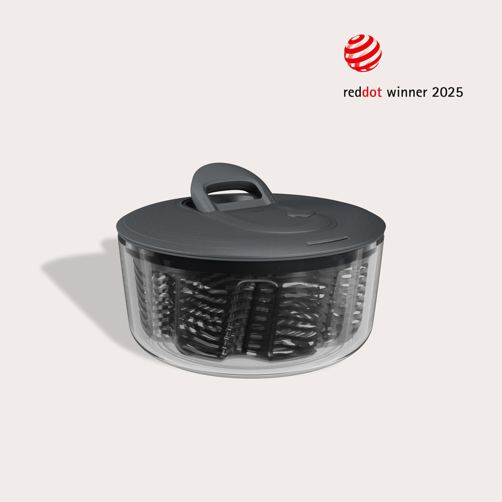 #small grey and clear easy spin salad spinner on off white beige background with red dot award winner logo in right corner