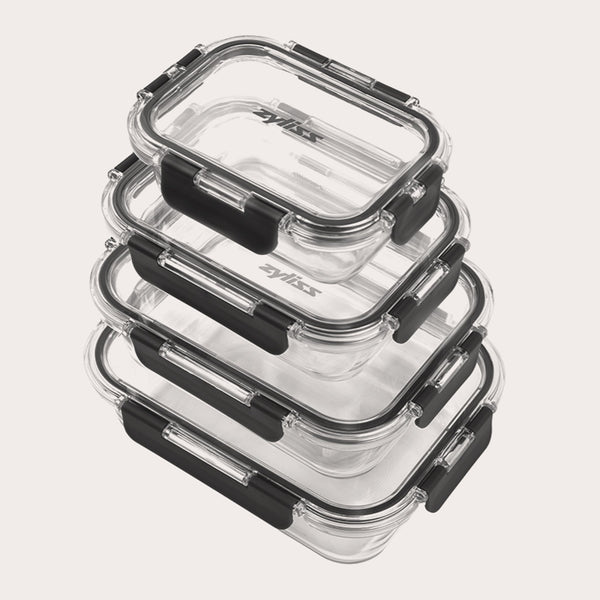 The Zyliss 4-Piece Glass Container Set features clear borosilicate containers with black locking lids, stacked neatly for leak-proof food storage against a plain white background. 