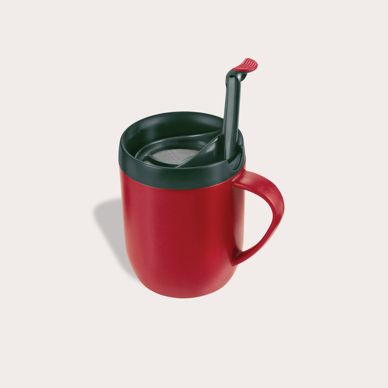 The Zyliss Hot Mug Cafetière Mug in red features a handle, double-wall insulation, dark green lid, and matching green spoon on a light background—ideal for coffee lovers on the move. #red