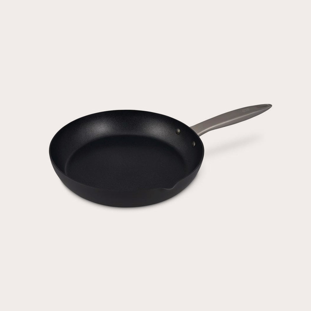 The Zyliss Ultimate Pro Non-Stick Frying Pan With Pouring Lip features a black, Swiss-coated hard-anodized aluminum body and a long gray handle, shown on a plain white background. #20cm/8"