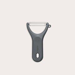 A Zyliss Y Peeler with a stainless steel swivel blade, ergonomic handle, and end hole is shown in black on a plain white background. 