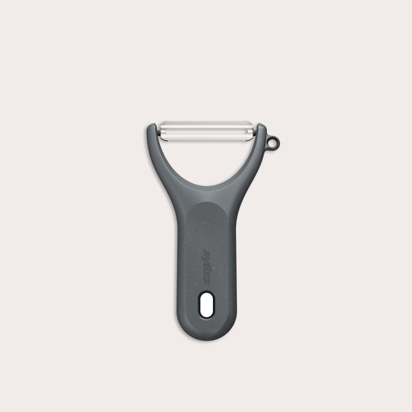 A Zyliss Y Peeler with a stainless steel swivel blade, ergonomic handle, and end hole is shown in black on a plain white background. 
