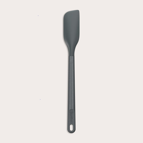 The Zyliss Spatula, featuring a long handle and flat, angled grey silicone head, is displayed against a plain white background.